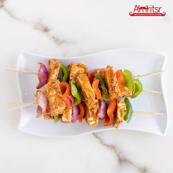 masala coated paneer and vegetables on skewers